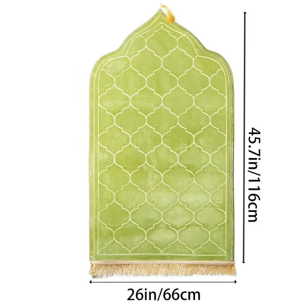 A light green prayer rug with a diamond lattice pattern and decorative tassels.