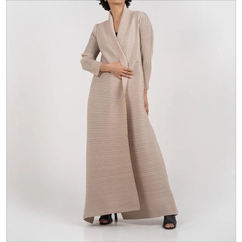 Une femme portant un trench-coat à manches longues à rayures beige plissées.
