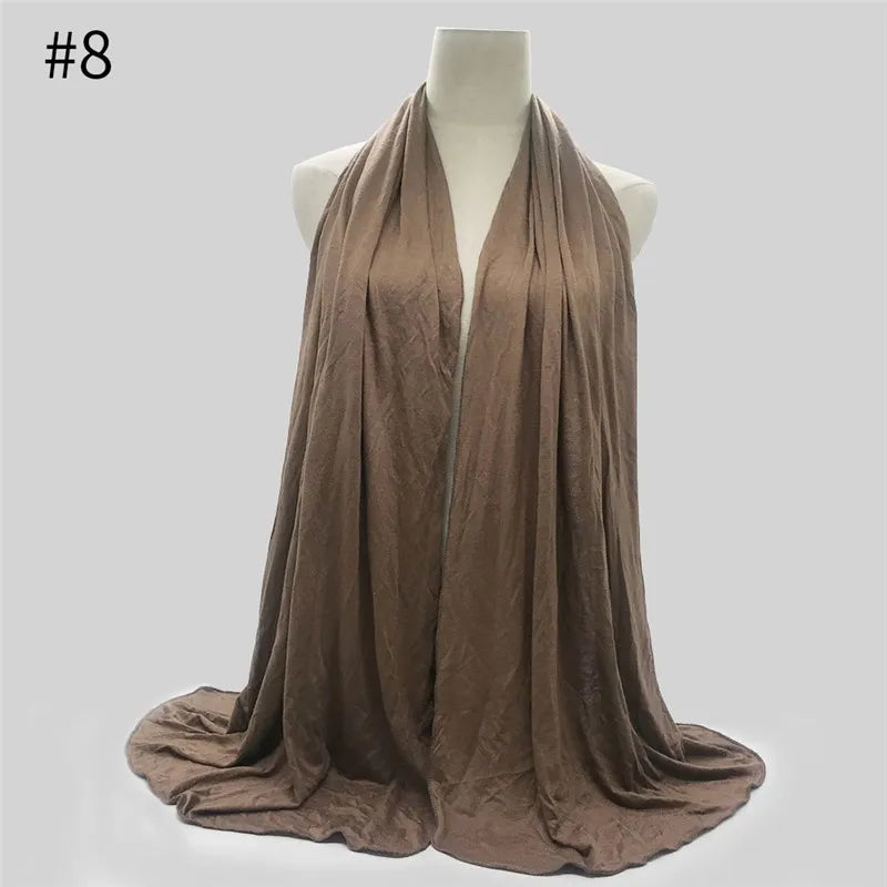 Ein drapierter brauner Baumwoll-Jersey-Hijab-Schal auf einem Mannequin.