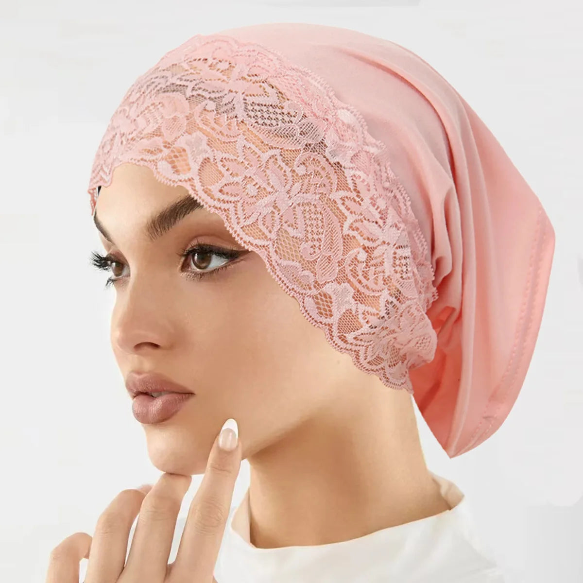 Model wearing a pink lace knit inner hijab undercap turban bonnet