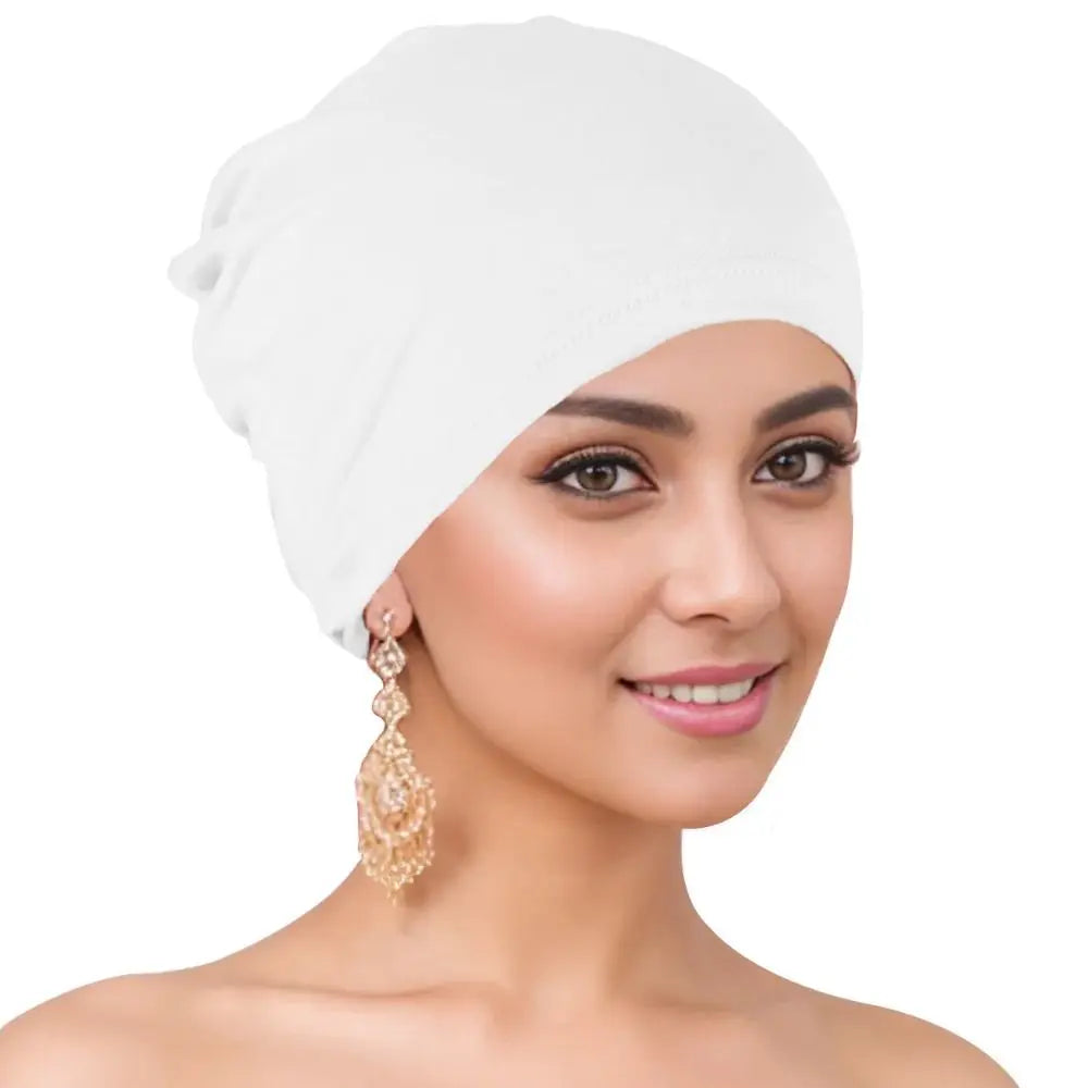 A woman wearing a white breathable cotton underscarf with an elastic fit