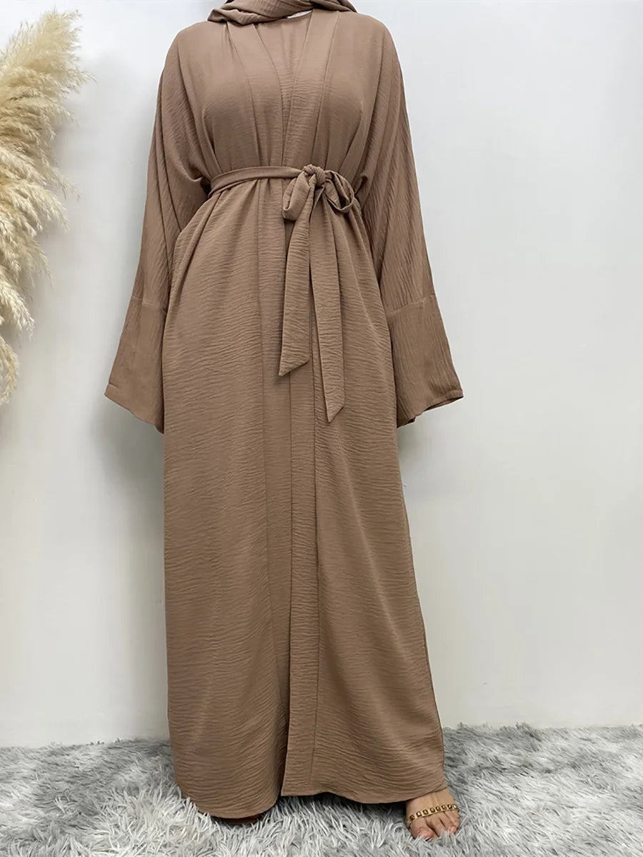 A full-length, loose-fitting brown abaya or kaftan dress with a tied neck and waist detail.