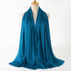 A teal blue premium modal jersey hijab draped around a mannequin's neck.