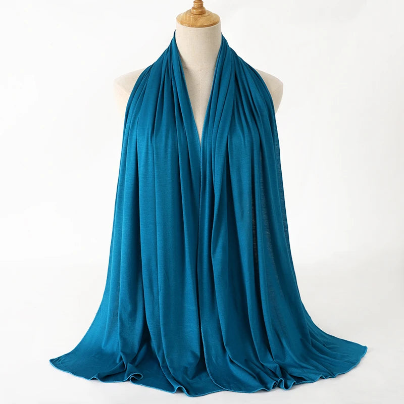 A teal blue premium modal jersey hijab draped around a mannequin's neck.