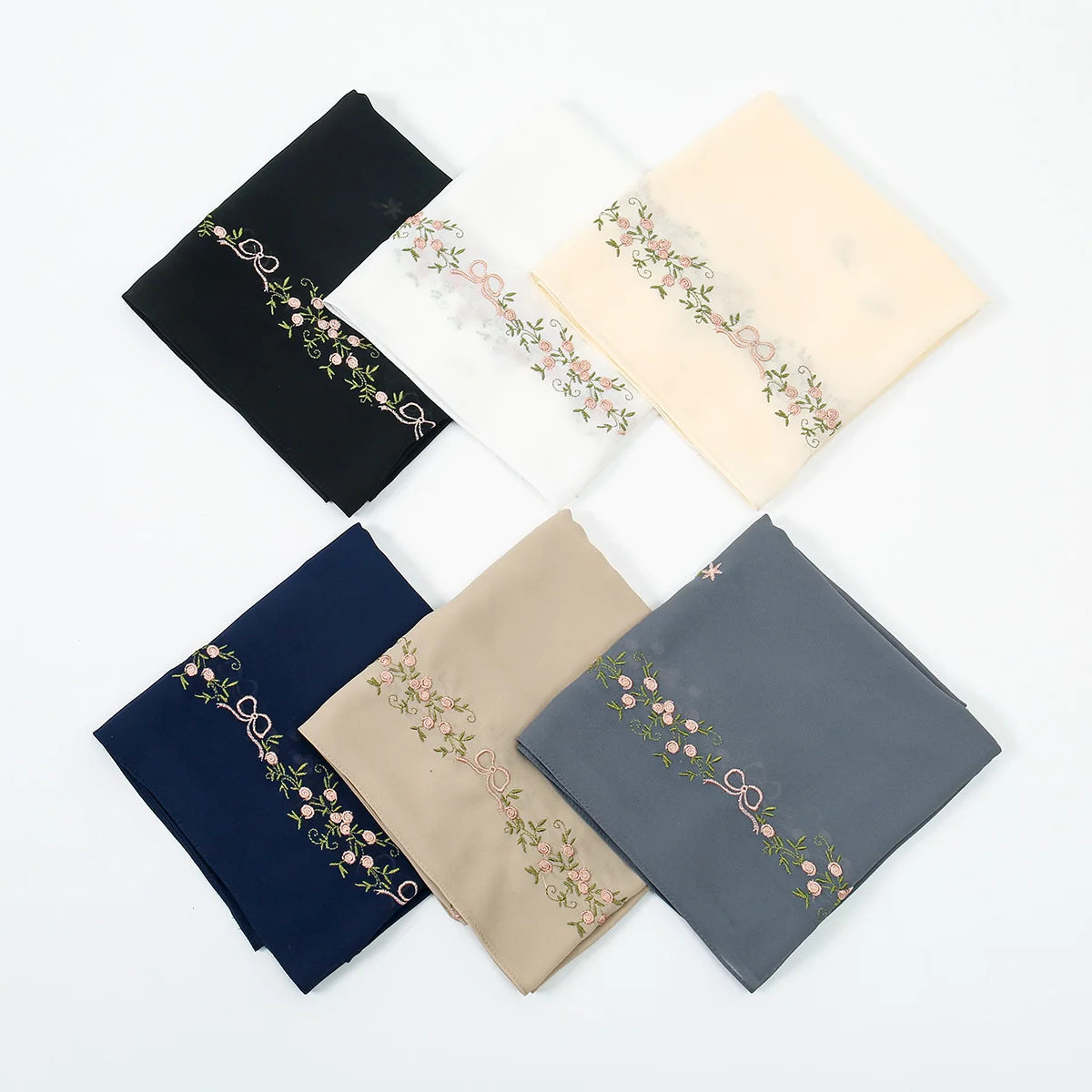 A collection of five elegant floral embroidery chiffon hijab shawls in shades of black, white, cream, and blue-gray.