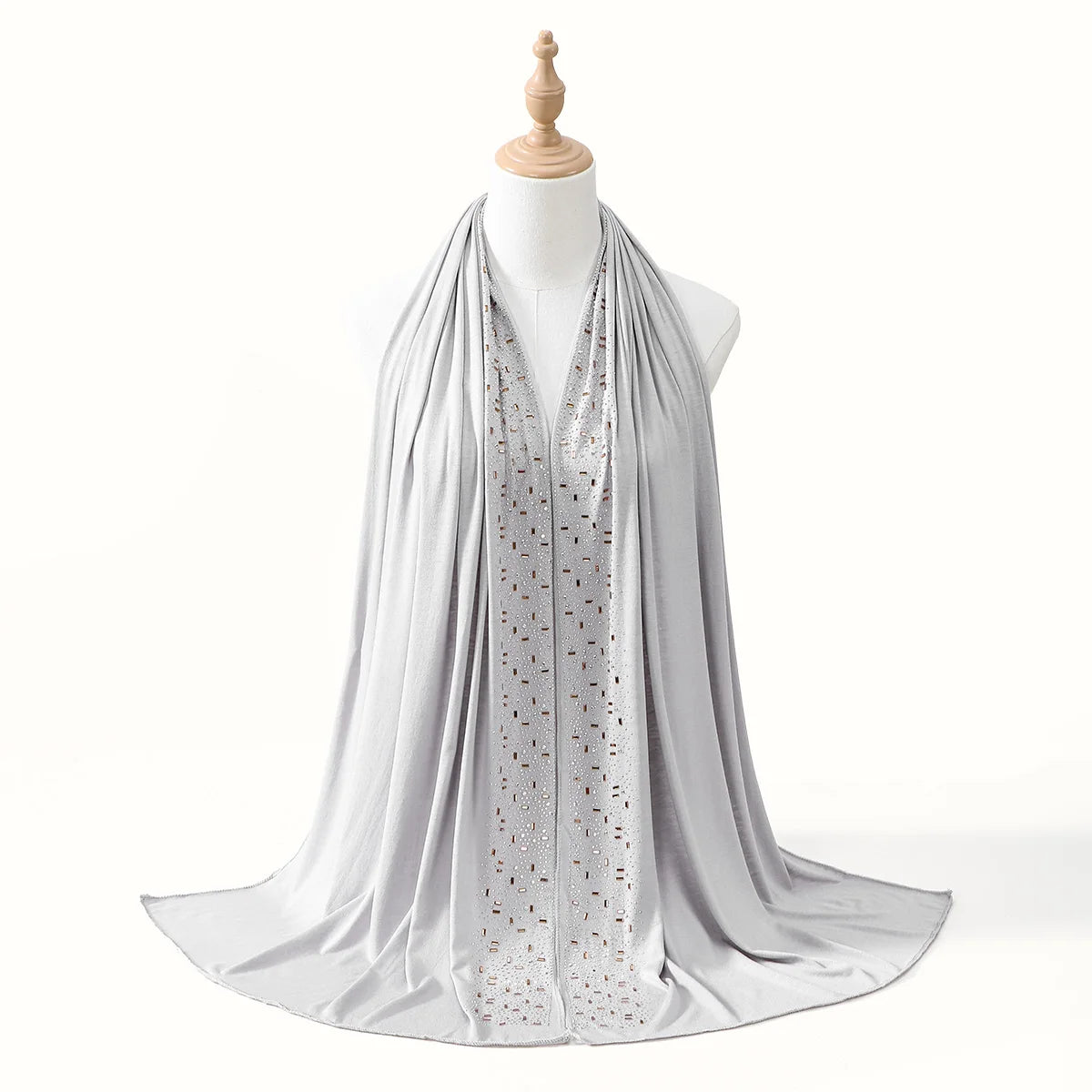 Fließender silberner Luxus-Rhinestone-Hijab-Schal über einem Mannequin-Hals.