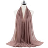A soft mauve chiffon hijab scarf draped around a mannequin's neck.