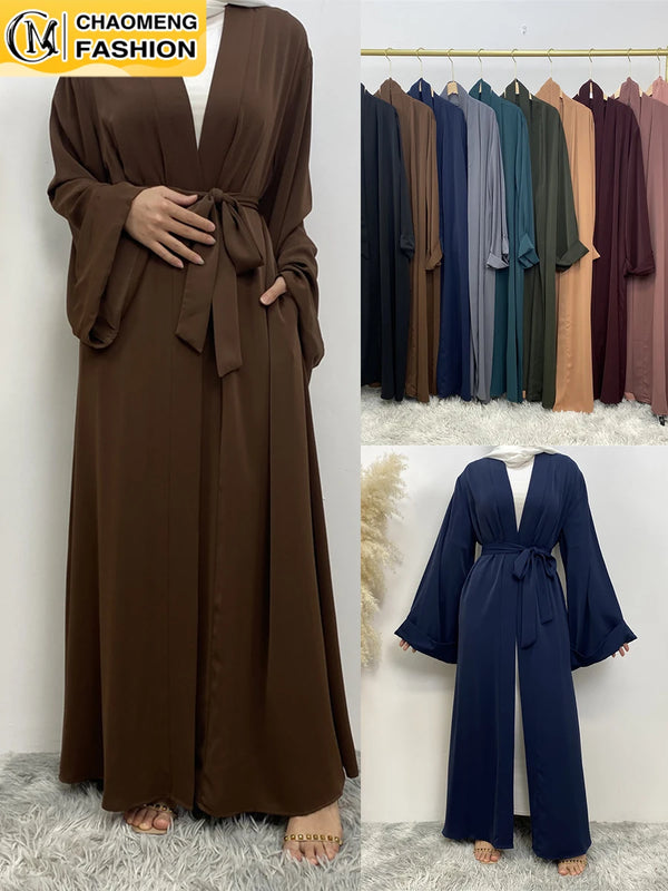 A model wears a long, flowy, open-front abaya kaftan in dark brown fabric.