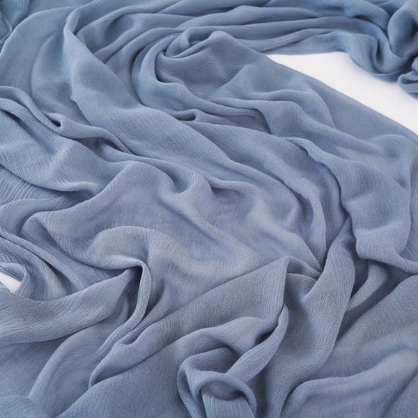 A soft blue gray viscose hijab scarf draped in flowing fabric.
