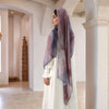 A woman wearing a white dress and a purple watercolor print modal scarf stands in a bright, modern interior.