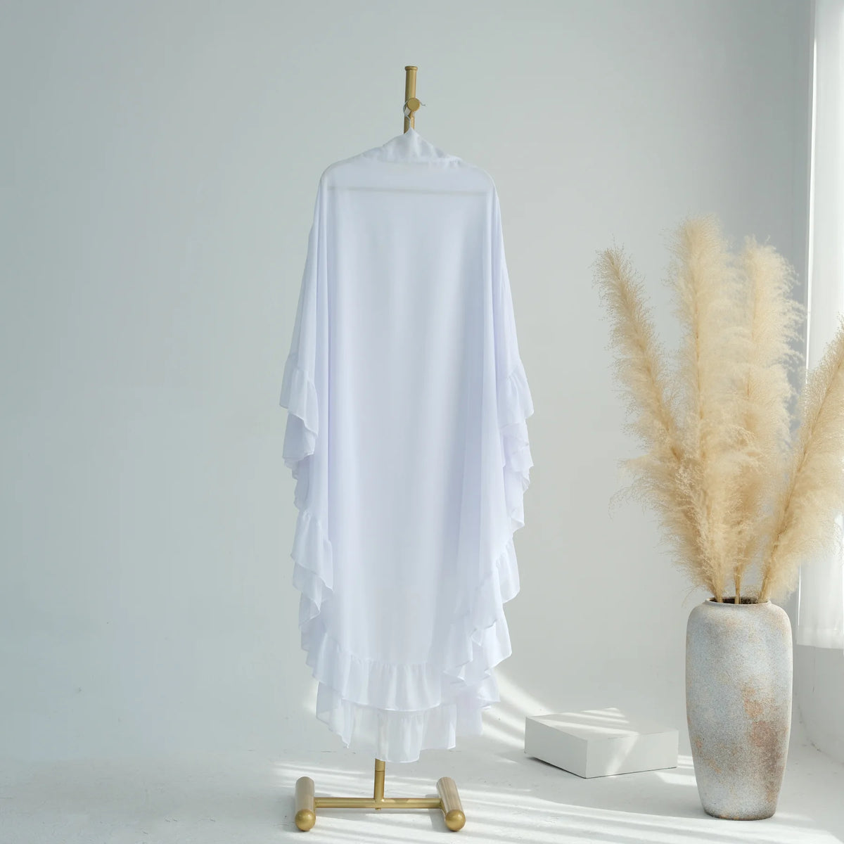 White ruffled 2-layer chiffon hijab displayed on a hanger against a light background.
