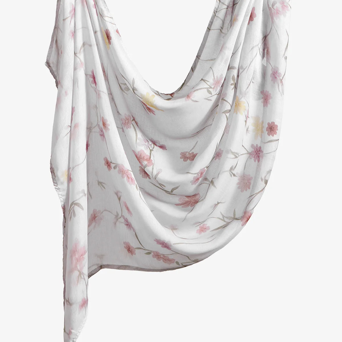 Un foulard hijab blanc doux et fluide avec un imprimé floral de fleurs roses et jaunes.