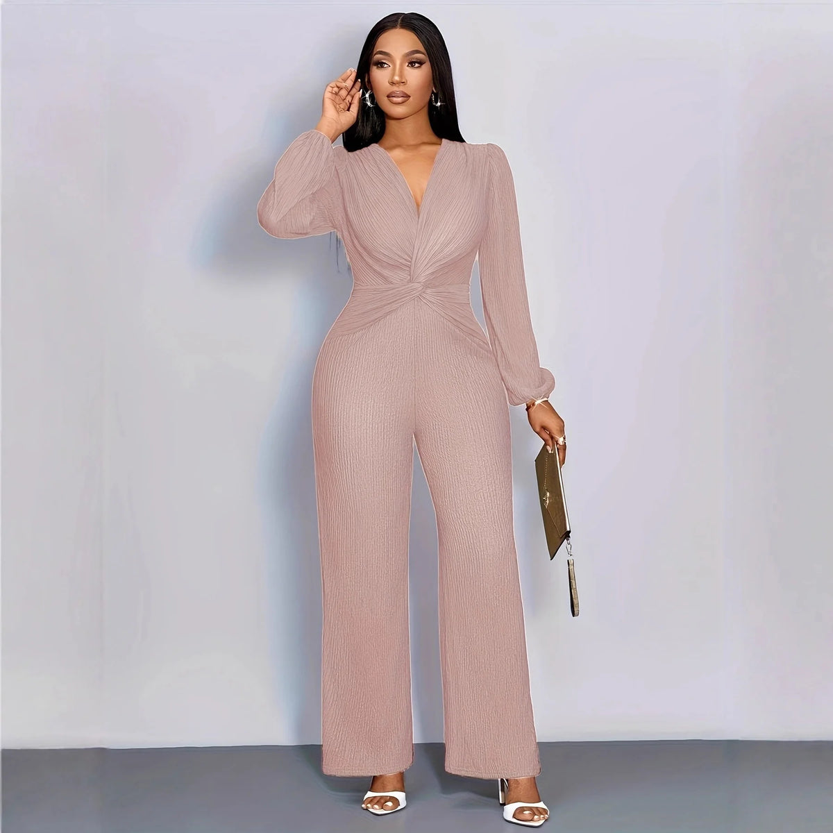 A model wearing a long-sleeved, ribbed knit jumpsuit in dusty rose color.