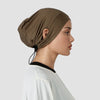 A model wearing a brown adjustable modal hijab cap with black elastic bands and a white top.
