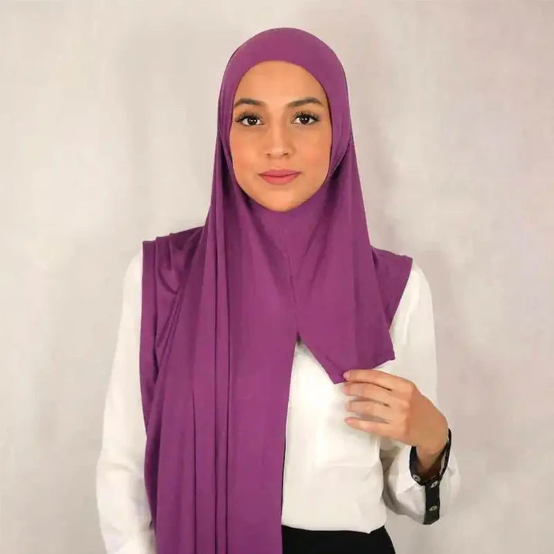Eine Frau trägt einen lila weichen Baumwoll-Jersey Instant-Hijab-Schal und ein weißes Oberteil.