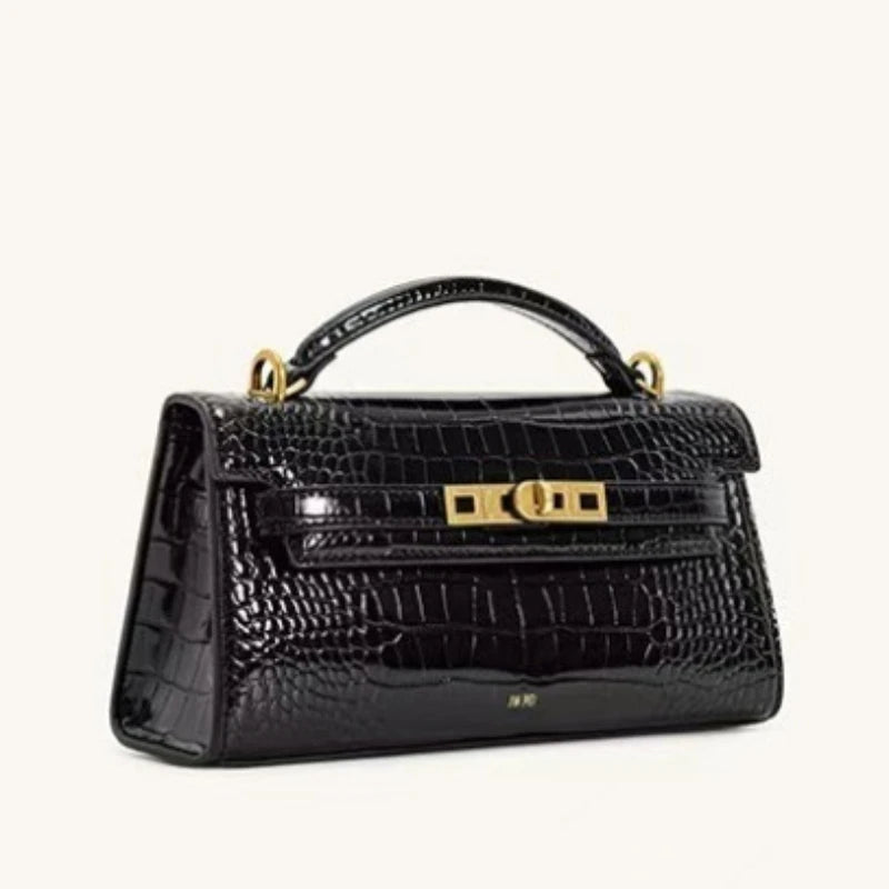 A black crocodile pattern shoulder bag with gold hardware.