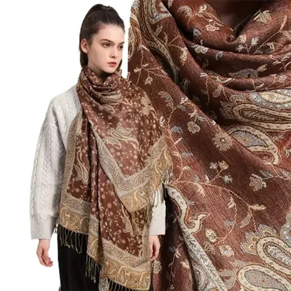 A woman models an elegant brown paisley viscose hijab scarf draped around her neck and shoulders.
