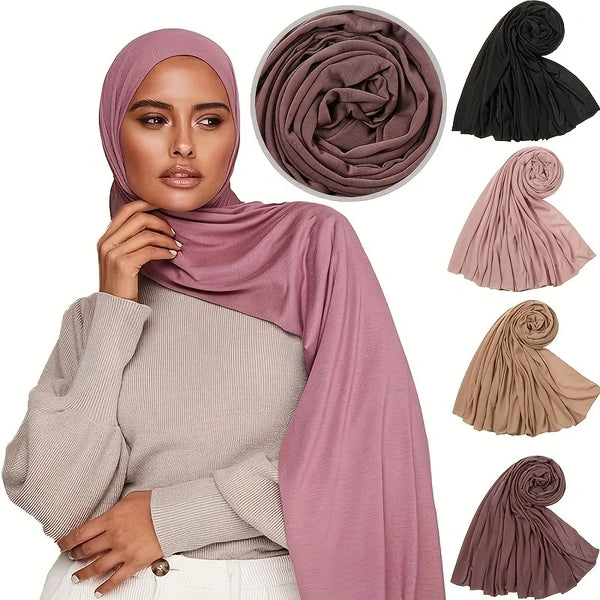 A woman models a dusty rose colored cotton jersey hijab scarf draped over a beige top.