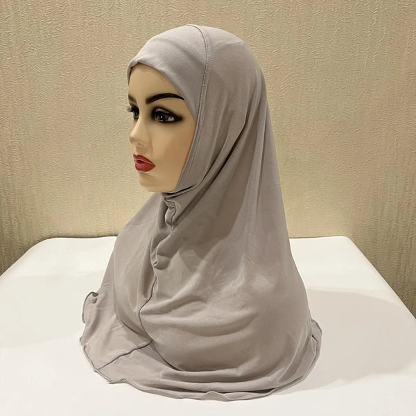 A light gray kids' Ramadan hijab shawl draped over a mannequin head.