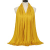 A mustard yellow soft modal jersey hijab scarf draped around a mannequin's neck.