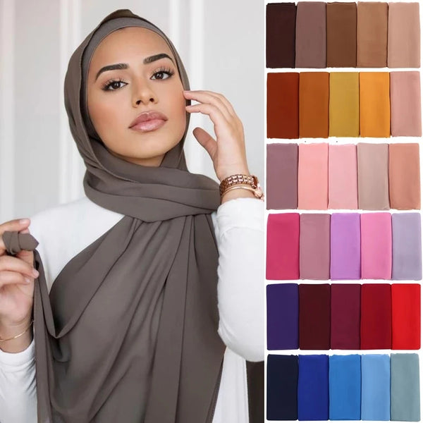 A woman models a solid brown chiffon hijab scarf with white clothing.