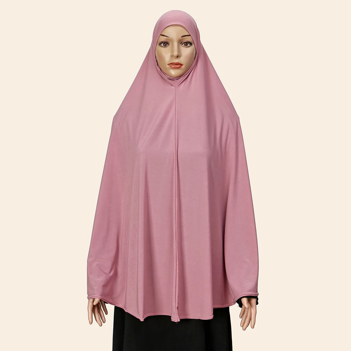 Model wearing a pink full-cover abaya with an inner hijab.