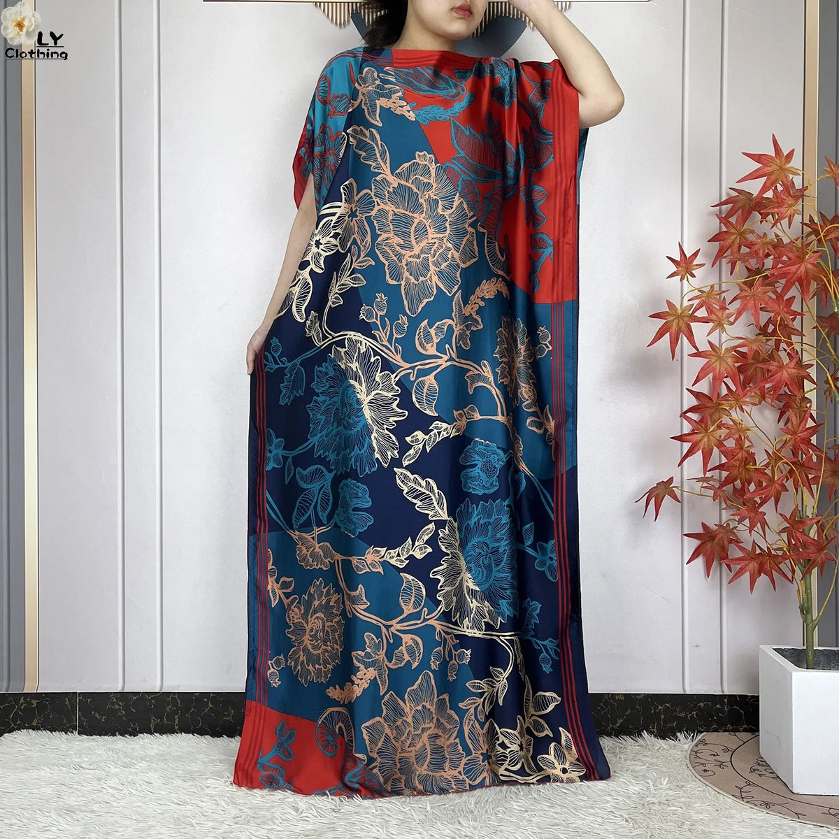 Eine Frau trägt ein blau-rotes Blumenmuster-Sommerseiden-Abaya-Kaftankleid