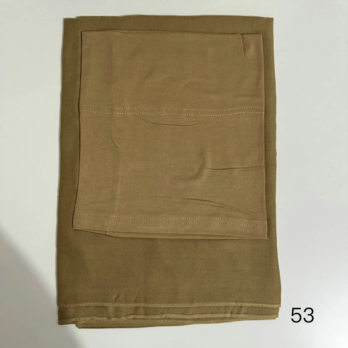 A solid olive green soft modal rayon hijab set folded neatly.