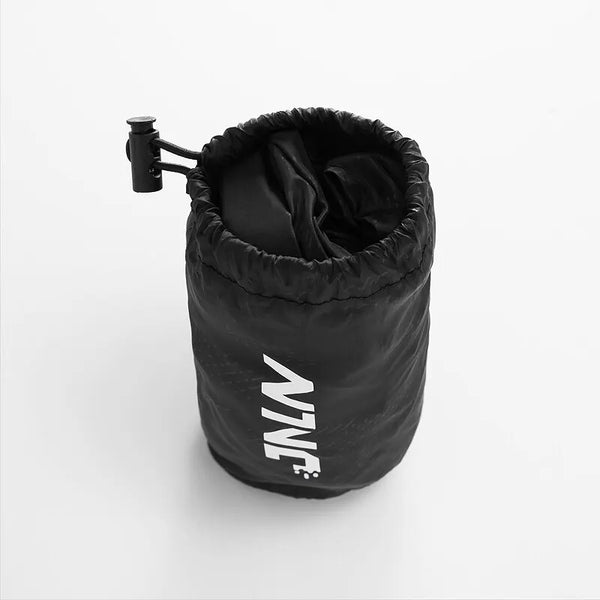 Black waterproof hiking pants rolled up with a black strap visible.