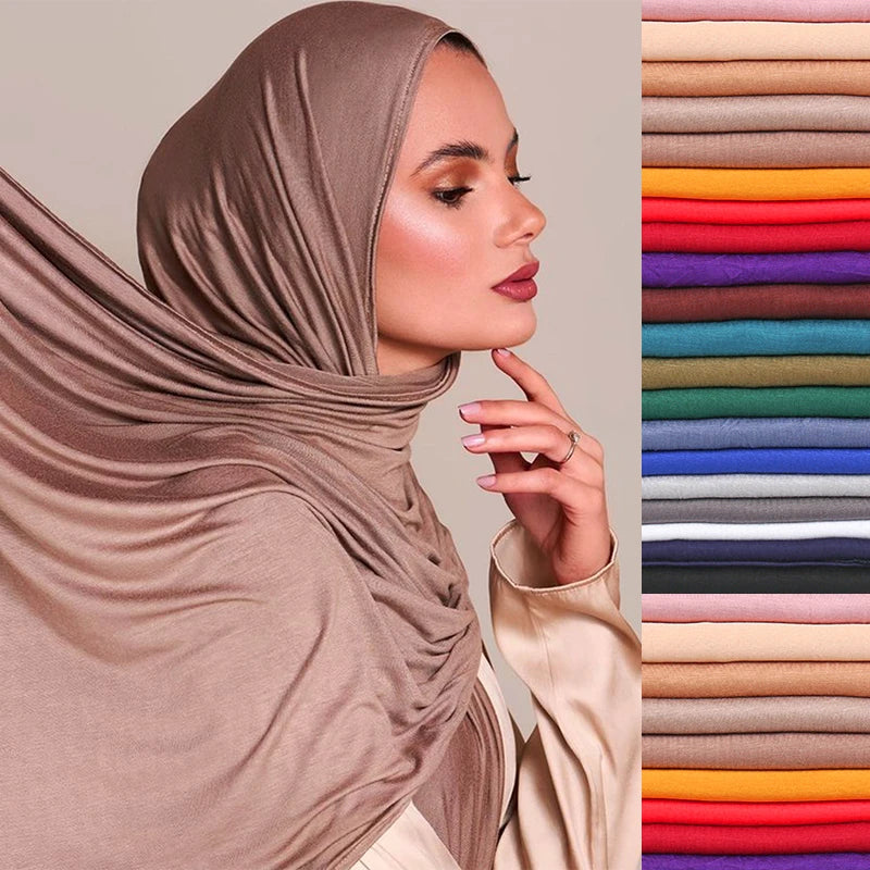 A woman wearing a mocha brown premium modal jersey hijab, shown in profile next to a color swatch chart.