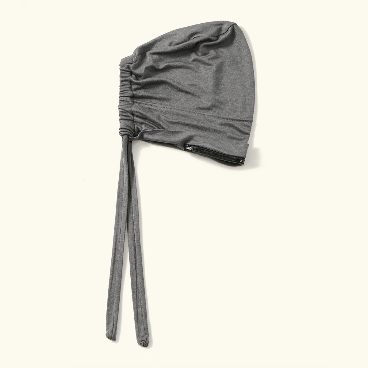 A gray adjustable elastic headband hijab cap for women shown flat lay.