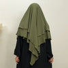 A woman wearing a olive green two-layer everyday hijab scarf over a black garment.