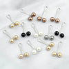 Sammlung von silbernen Drop-Pins mit Perlen und schwarzen Perlen zum Halten von Hijab und Schals.