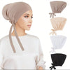 A model wearing a beige anti-slip inner hijab cap with matching fabric ties and a white top.
