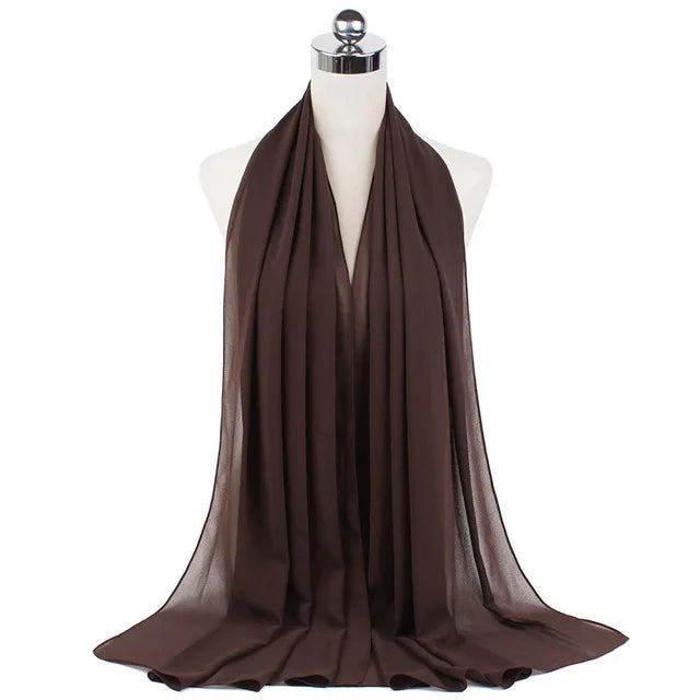 A dark brown chiffon hijab scarf draped around a mannequin's neck.