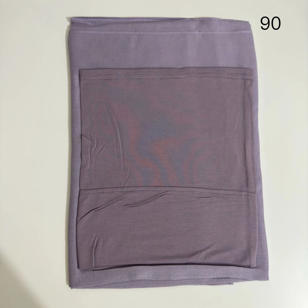 A solid lavender soft modal rayon hijab set folded flat.