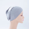 Helle graue Bambus-Jersey-Turban-Kappe auf einem Mannequin-Kopf.