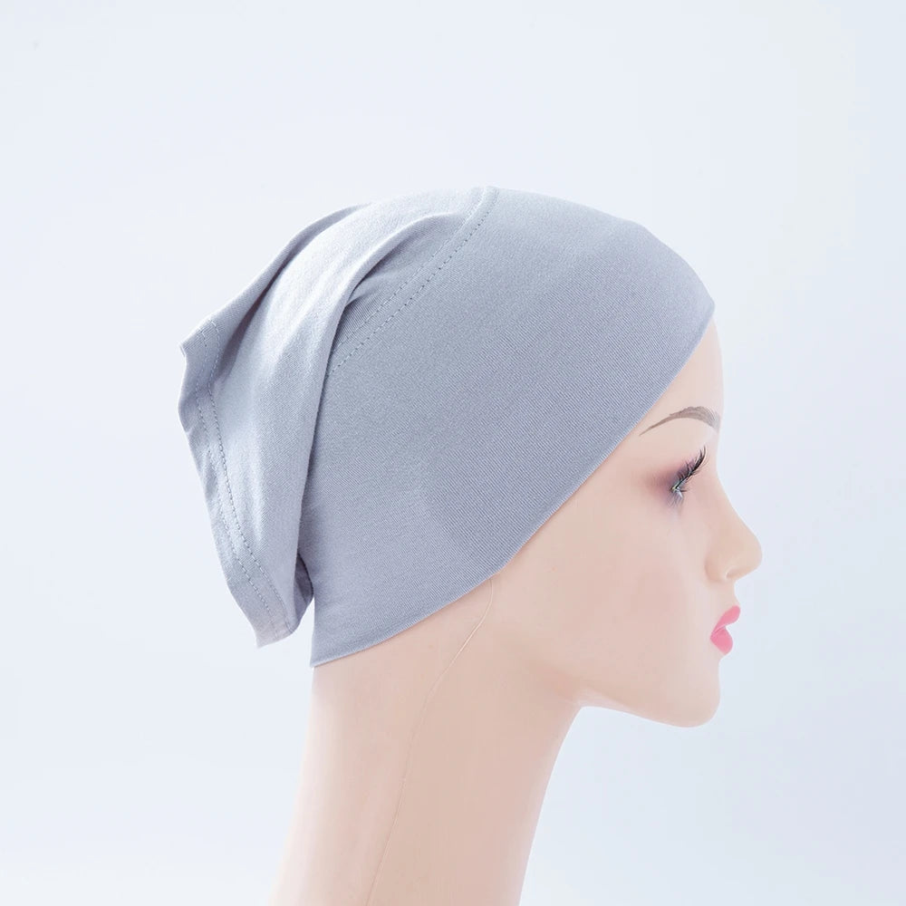 Helle graue Bambus-Jersey-Turban-Kappe auf einem Mannequin-Kopf.