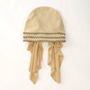 Beige elastisches Kopftuch mit schwarzem Streifenrand und drapierten Enden.