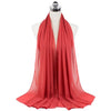 A vibrant coral red chiffon hijab scarf draped on a mannequin.