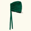 A deep emerald green anti-slip inner hijab cap with a long tie visible.