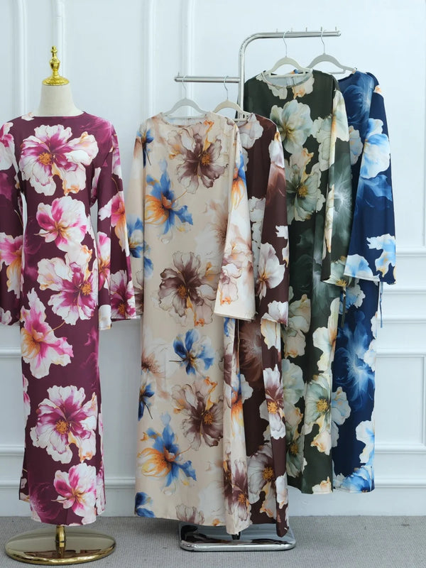 A display of luxury floral print abayas for women in various colors and patterns.