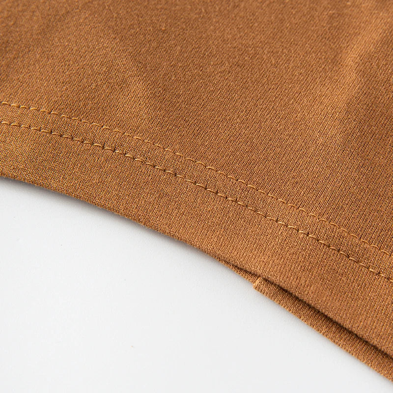 Close-up of a brown chiffon fabric with visible stitching on a garment edge.