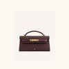 A dark brown leather shoulder bag with a gold-toned clasp and crocodile pattern texture.