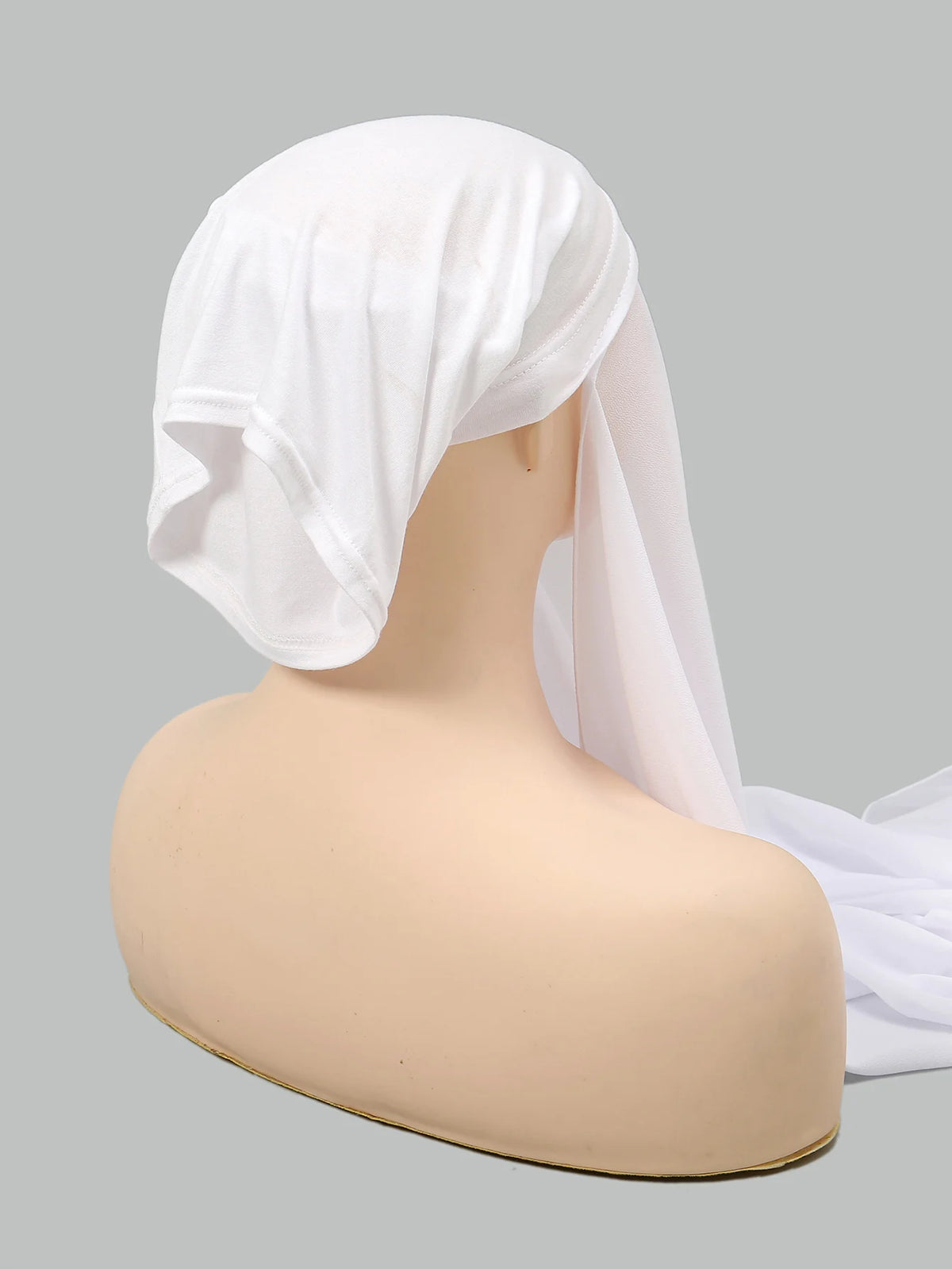 A white chiffon instant hijab is displayed on a mannequin head.