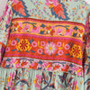 Vestido largo bohemio color menta claro con estampados florales vibrantes en rosa, naranja y púrpura.