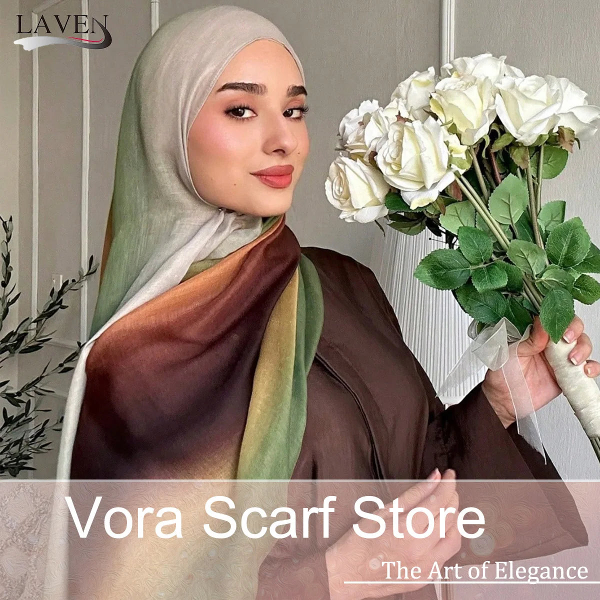 A woman wearing an elegant watercolor print modal scarf in shades of olive green and brown, holding a bouquet of white roses.