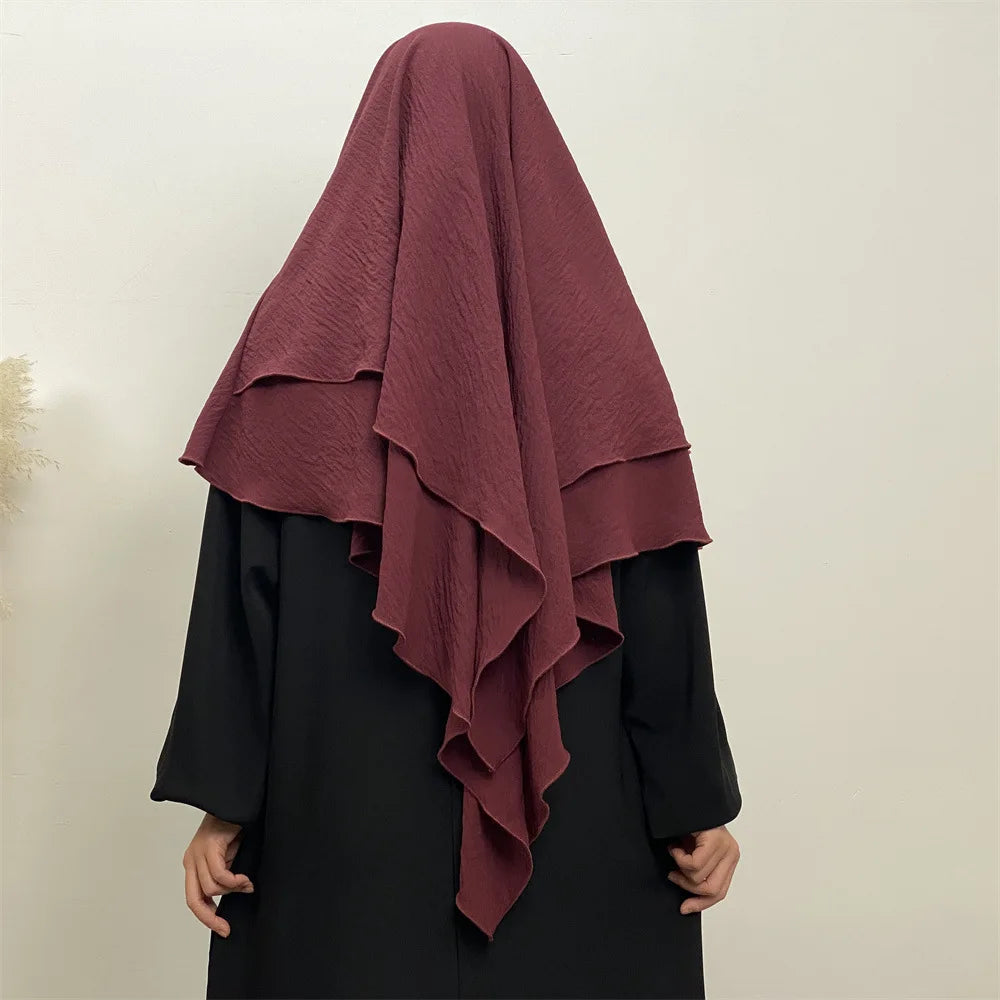 A maroon two-layer everyday hijab scarf draped over a black garment.