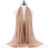 A beige chiffon hijab scarf draped around a mannequin's neck.