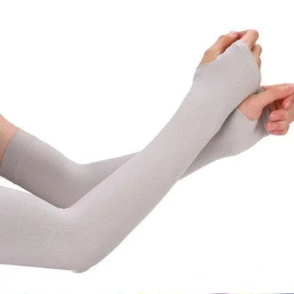 A close-up of a light gray cooling UV protection arm sleeve being worn on an arm.